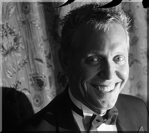 Close up photo of Jerry Michelsen, smiling, in a tuxedo.