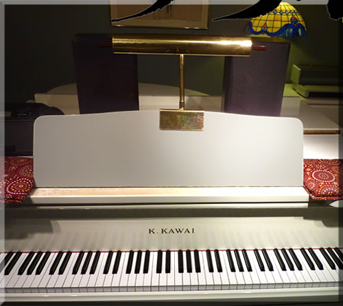 Photo of the keyboard of the white grand piano in the studio of Jerry Michelsen